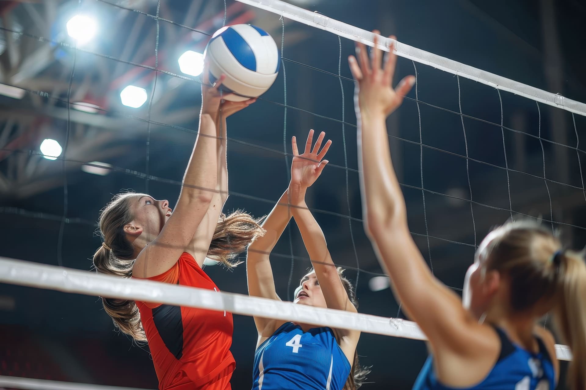 A close-up of intense volleyball match action, with players atte
